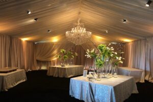 Custom champagne satin perimeter ivory sheer layering drapery event rental Wedding Alabama tent