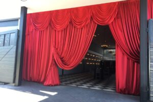 red flourish tc book release red satin swags entryway drape atlanta quest events rental