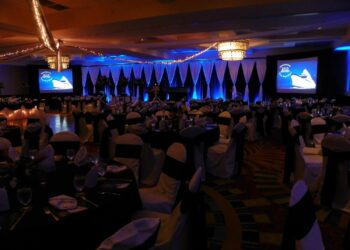 Quest Events Corporate Event Meeting Drape Hourglass Stage Backdrop AV Surround White Black Uplighting 1